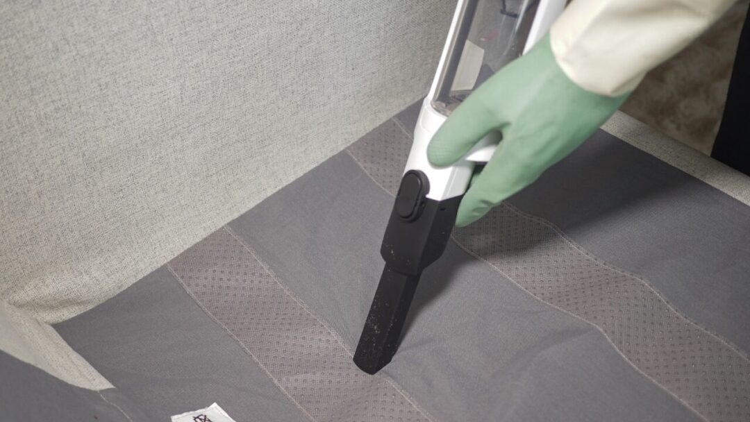 2. Cleaning fabric surface with a handheld vacuum cleaner